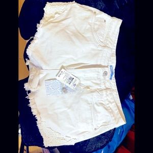 White denim shorts with tags